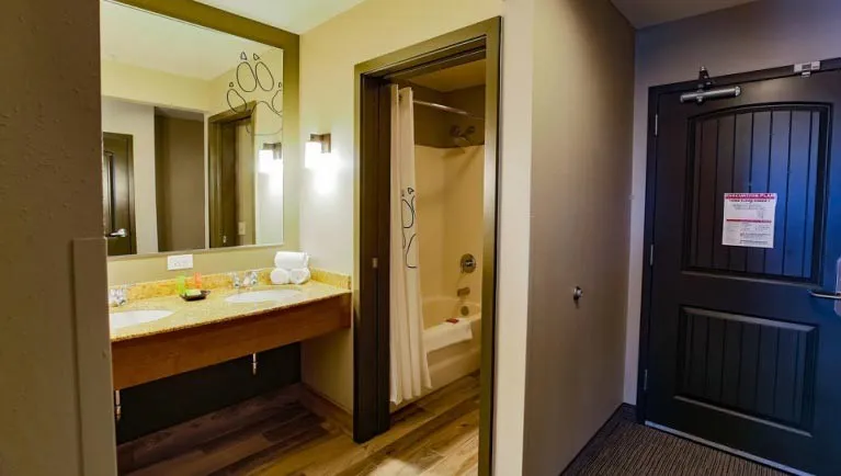 The entryway and bathroom in the Family Suite